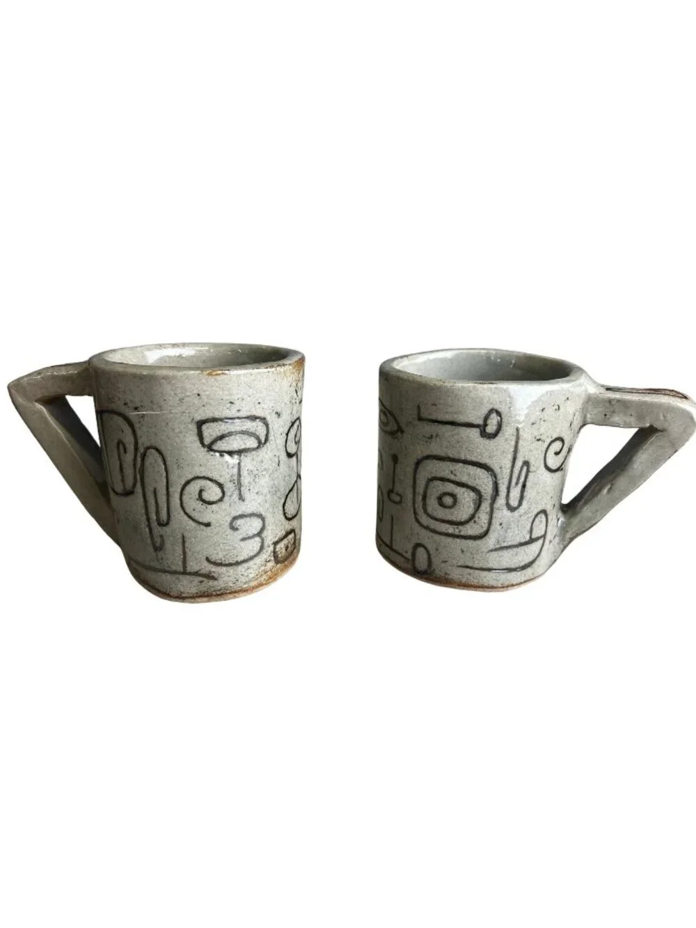 Pair of Hand-formed Mugs with Branding Iron Designs Angular Handles Beige